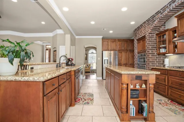 a kitchen with stainless steel appliances granite countertop a sink and cabinets