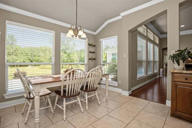 a view of a dining room with furniture large windows and wooden floor