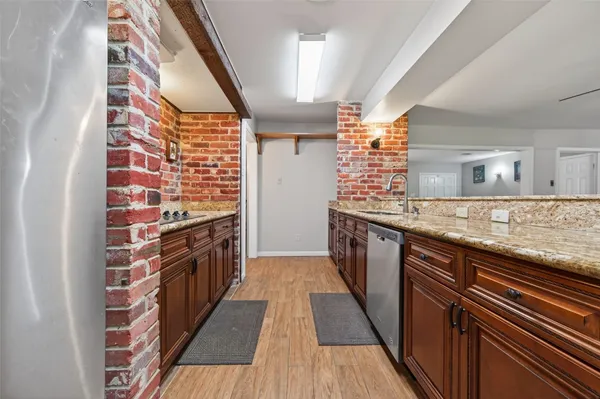 a kitchen with stainless steel appliances granite countertop a stove and cabinets
