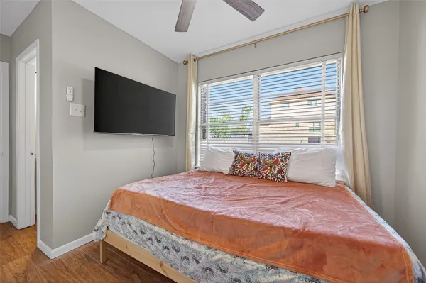 a bedroom with a bed and a flat screen tv