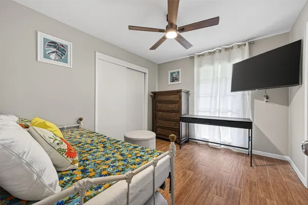 a bedroom with furniture and a flat screen tv