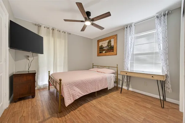 a bedroom with a bed and a flat screen tv