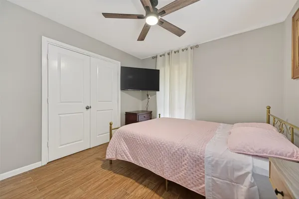 a bedroom with a bed and a flat tv screen