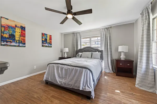 a bedroom with a bed and wooden floor