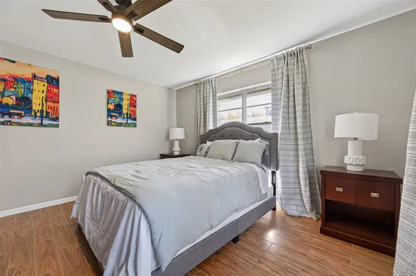 a bedroom with a bed and a painting on the wall