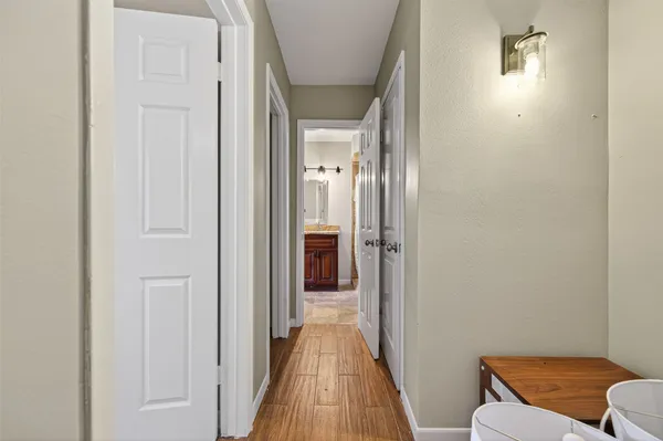 a view of a hallway with wooden floor