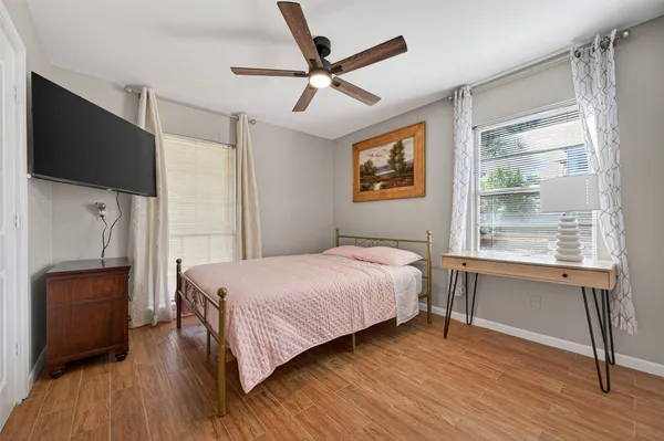 a bedroom with a bed and a flat screen tv