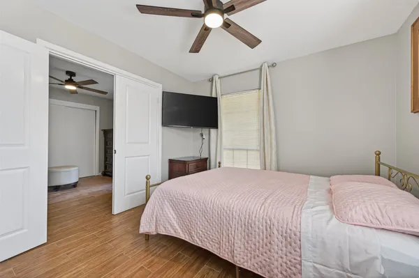 a bedroom with a bed and a flat screen tv