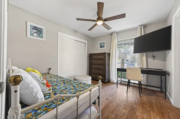 a bedroom that has a bed and a chair in it