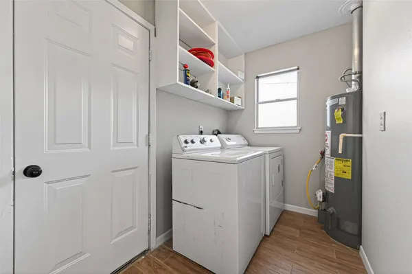 a utility room with cabinets washer and dryer
