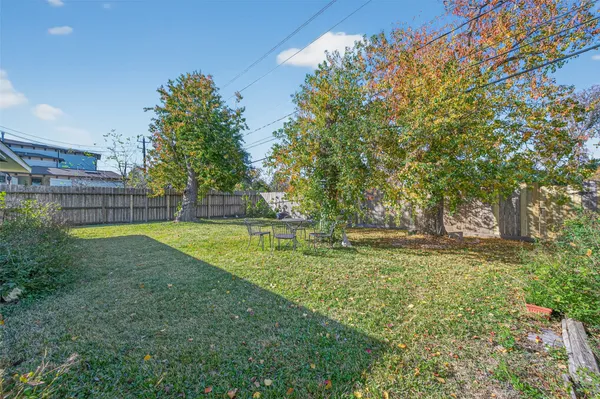a view of yard with tree and wooden fence