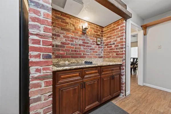 a view of granite counter top space and wooden floor