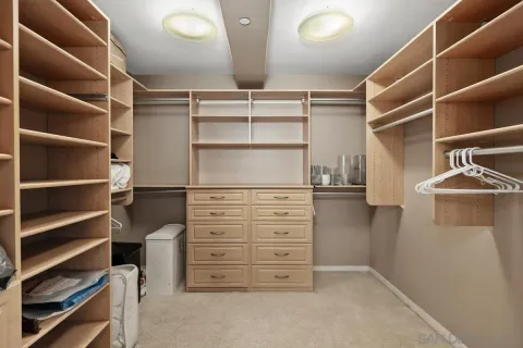 a view of walk in closet with empty racks