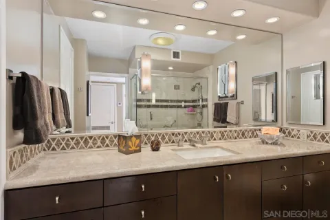 a bathroom with a sink double vanity and a mirror