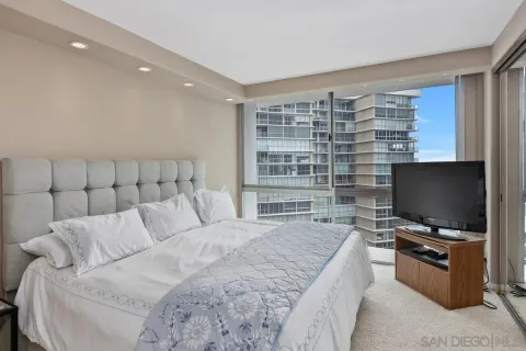 a bedroom with a bed and a flat screen tv
