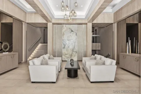 a living room with furniture and a chandelier