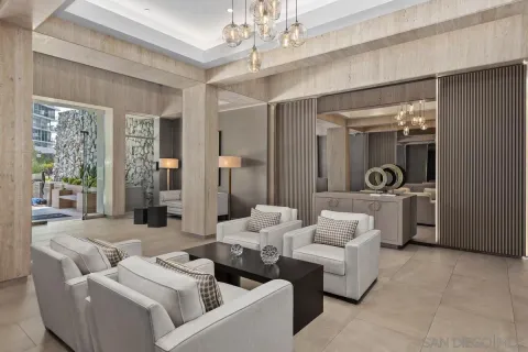a living room with furniture and a chandelier