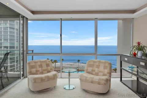 a living room with furniture and a floor to ceiling window