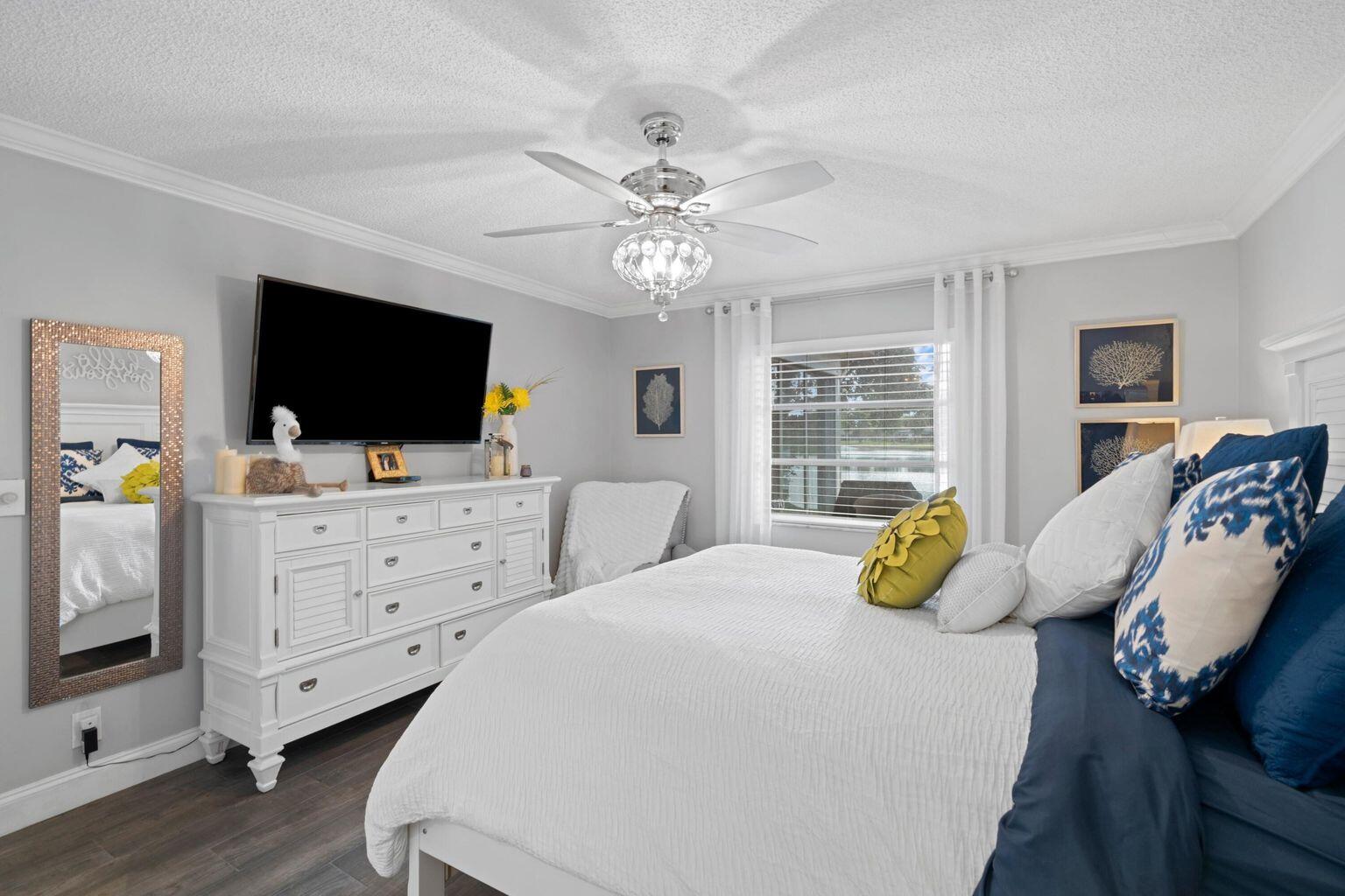 5400 Poppy Place, Unit B Delray Beach, FL 33484 - Photo 11 of 23 a bedroom with a bed and flat screen tv