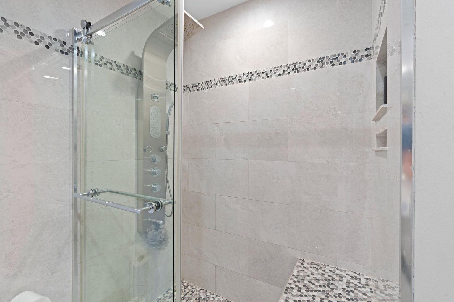 5400 Poppy Place, Unit B Delray Beach, FL 33484 - Photo 13 of 23 a bathroom with a glass shower door