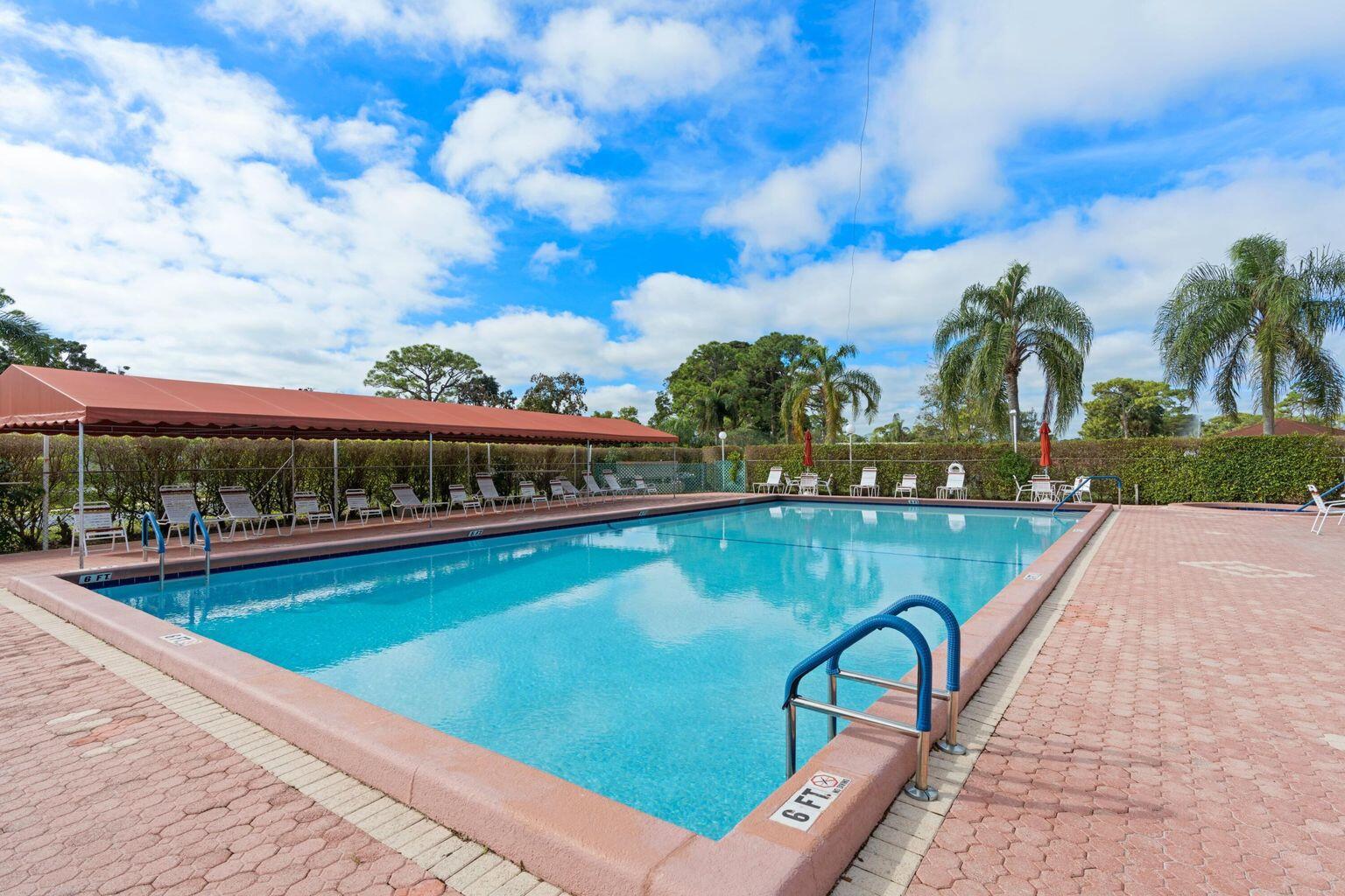 5400 Poppy Place, Unit B Delray Beach, FL 33484 - Photo 22 of 23 a view of swimming pool with outdoor seating and yard in back