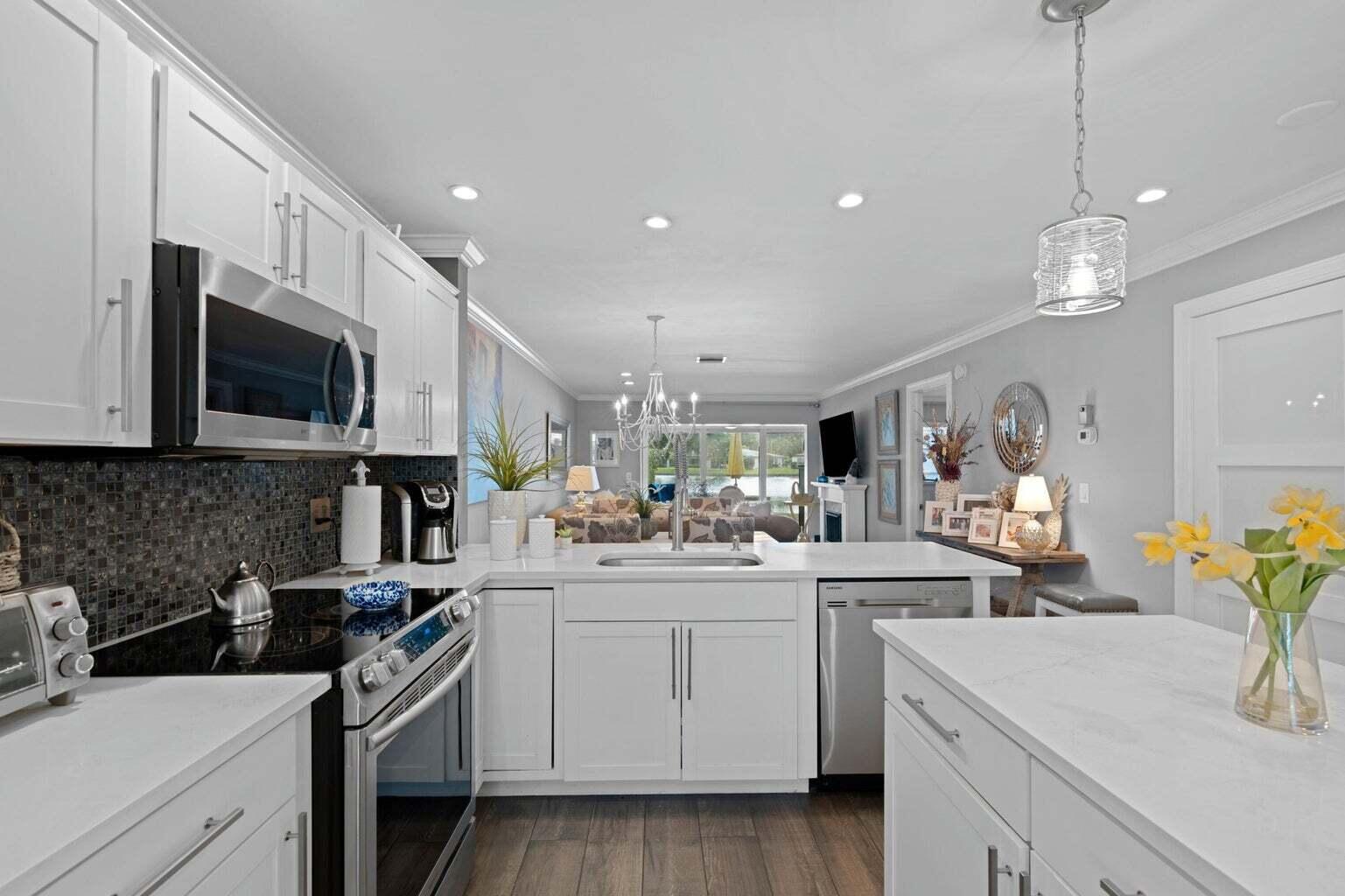 5400 Poppy Place, Unit B Delray Beach, FL 33484 - Photo 3 of 23 a kitchen with a sink stove and microwave