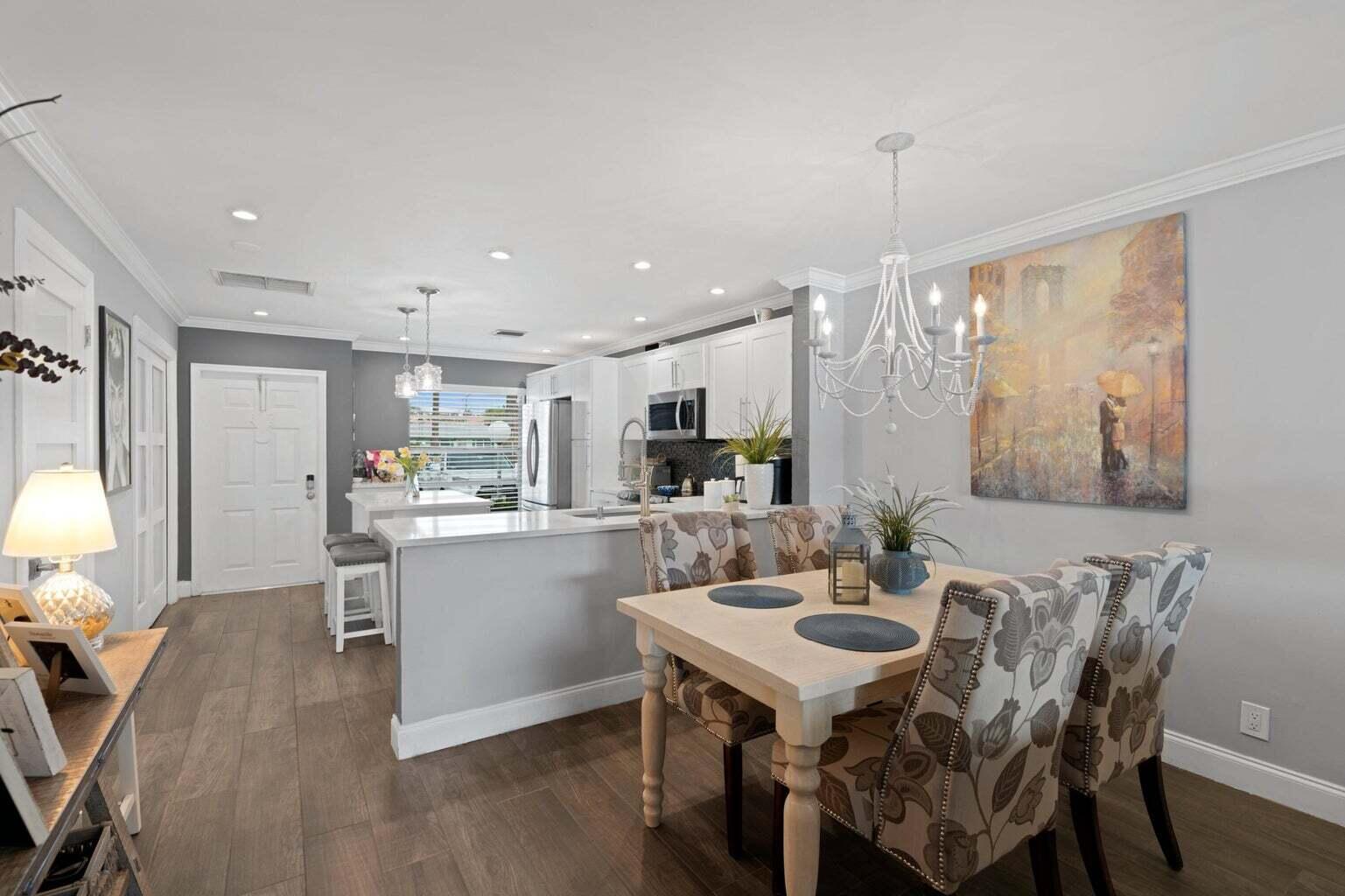 5400 Poppy Place, Unit B Delray Beach, FL 33484 - Photo 4 of 23 a kitchen with a table and chairs in it