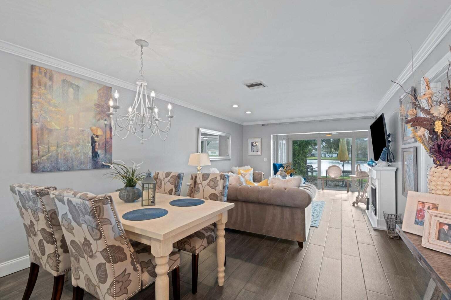 5400 Poppy Place, Unit B Delray Beach, FL 33484 - Photo 6 of 23 a view of a dining room with furniture window and wooden floor
