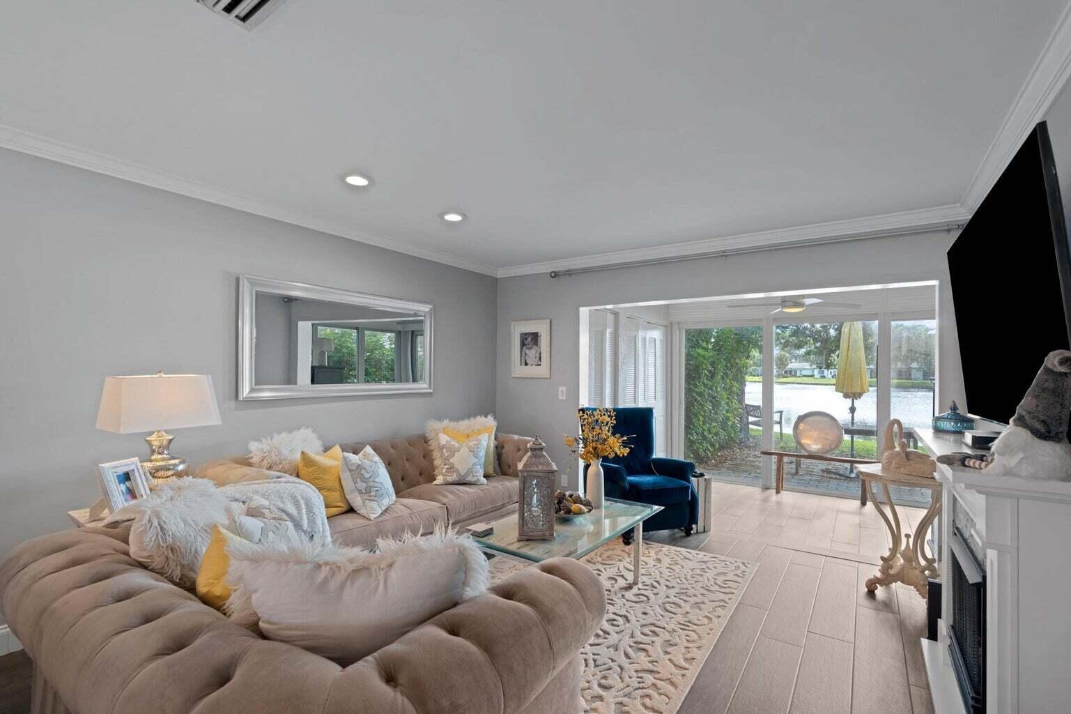 5400 Poppy Place, Unit B Delray Beach, FL 33484 - Photo 7 of 23 a living room with furniture and a flat screen tv