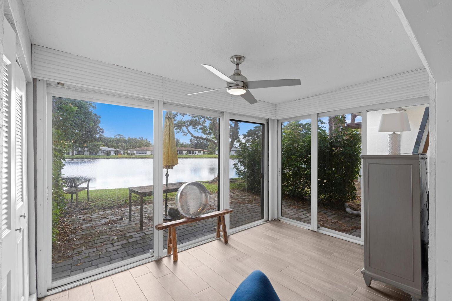 5400 Poppy Place, Unit B Delray Beach, FL 33484 - Photo 9 of 23 a workspace with wooden floor and a large window