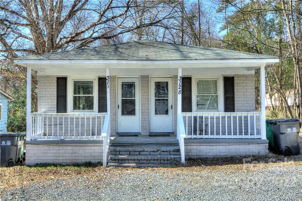 3128-3130 Ridge Avenue Charlotte, NC 28208 - Photo 1 of 22 a view of a house with a bench in back yard