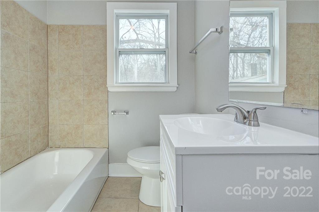 3128-3130 Ridge Avenue Charlotte, NC 28208 - Photo 11 of 22 a bathroom with a sink a toilet and tub