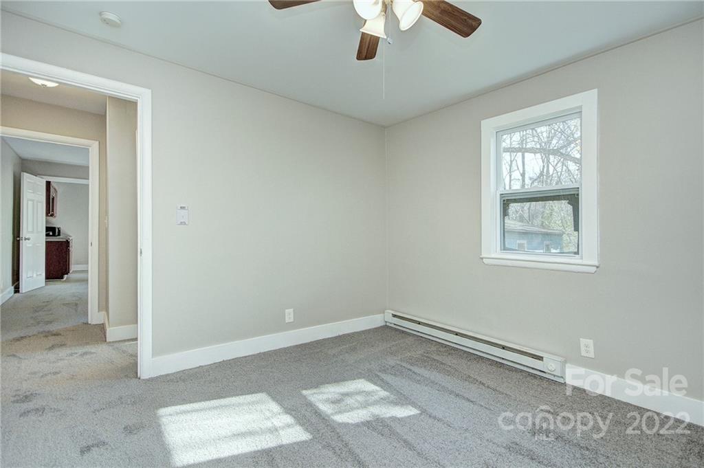 3128-3130 Ridge Avenue Charlotte, NC 28208 - Photo 12 of 22 an empty room with a window and a ceiling fan