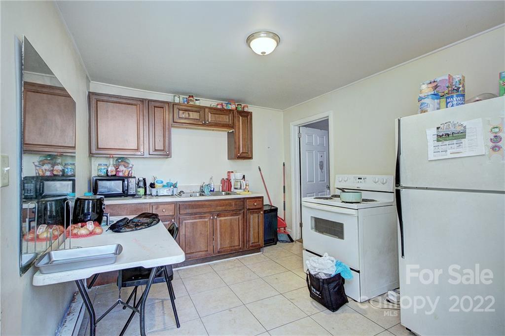 3128-3130 Ridge Avenue Charlotte, NC 28208 - Photo 17 of 22 a kitchen with a refrigerator and a stove top oven