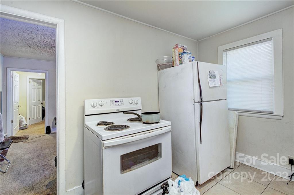 3128-3130 Ridge Avenue Charlotte, NC 28208 - Photo 18 of 22 a white refrigerator freezer and a stove sitting inside of a kitchen