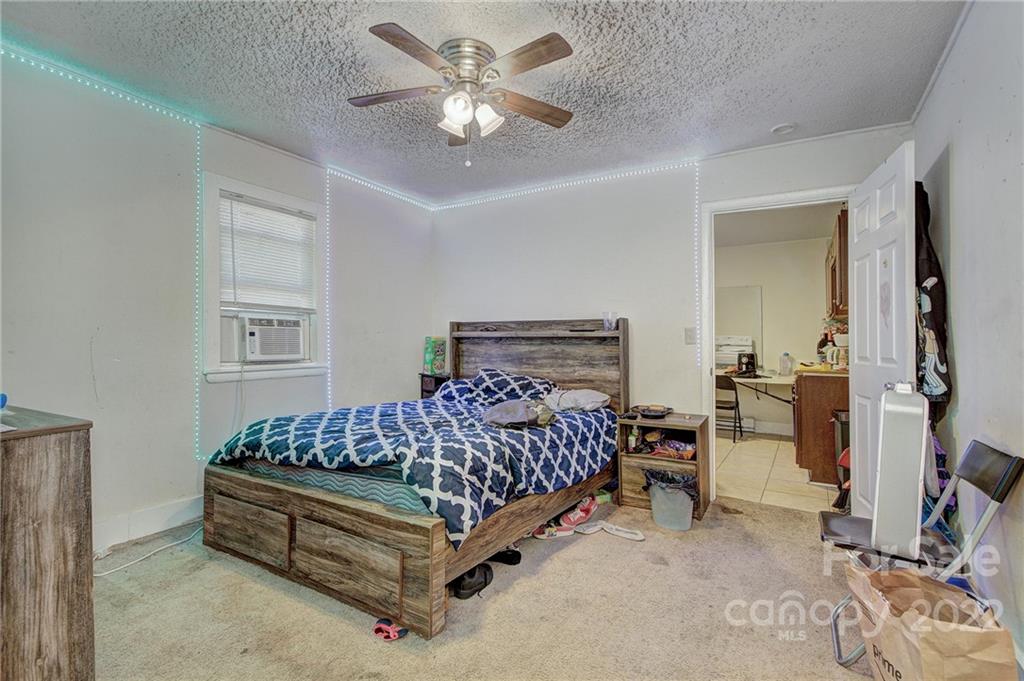 3128-3130 Ridge Avenue Charlotte, NC 28208 - Photo 19 of 22 a bed room with a bed and a ceiling fan
