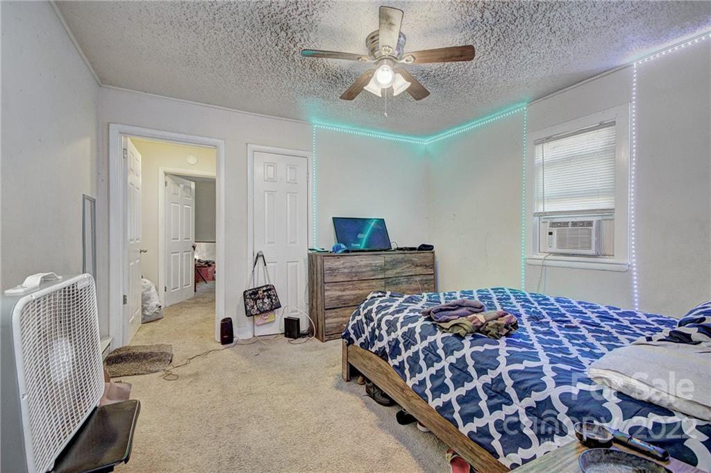 3128-3130 Ridge Avenue Charlotte, NC 28208 - Photo 20 of 22 a bedroom with a large bed and a chandelier