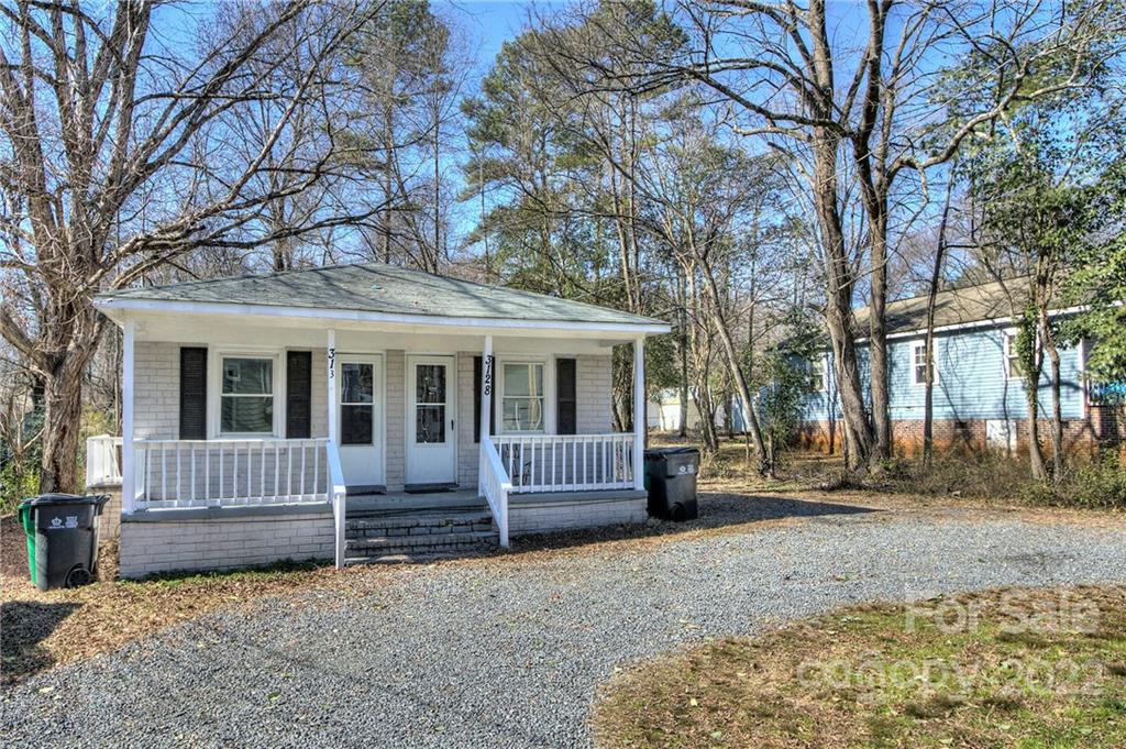 3128-3130 Ridge Avenue Charlotte, NC 28208 - Photo 2 of 22 a front view of a house with garden