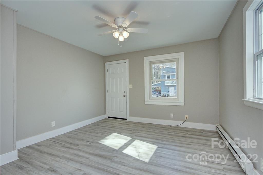3128-3130 Ridge Avenue Charlotte, NC 28208 - Photo 4 of 22 a view of an empty room with wooden floor and a window