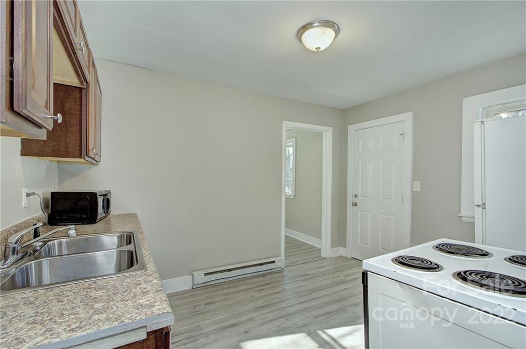 3128-3130 Ridge Avenue Charlotte, NC 28208 - Photo 5 of 22 a kitchen with granite countertop a stove and a sink