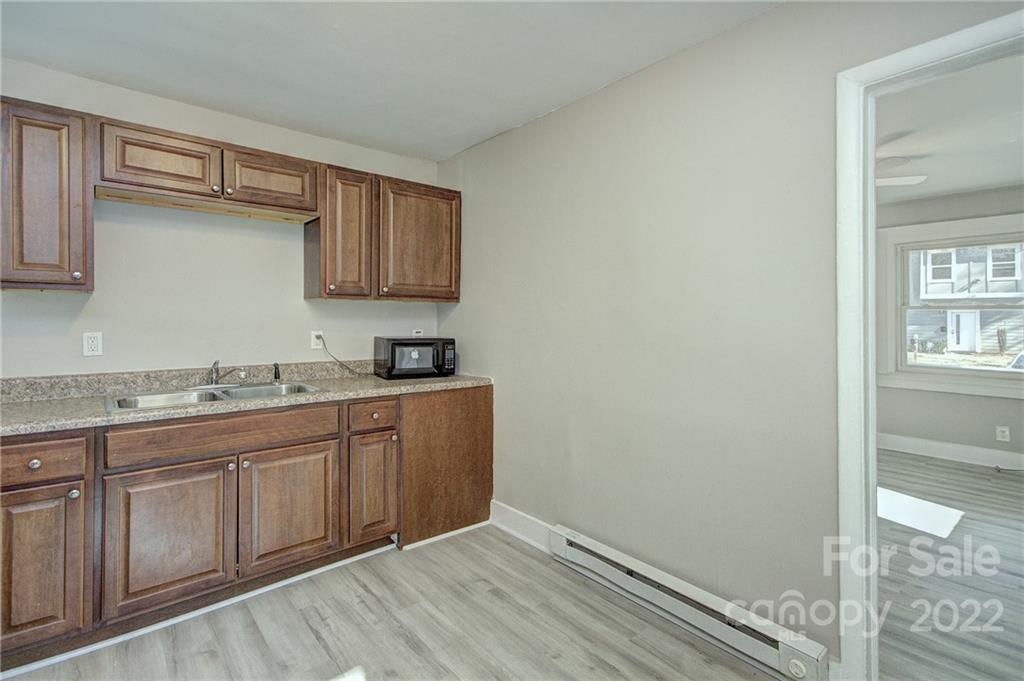 3128-3130 Ridge Avenue Charlotte, NC 28208 - Photo 6 of 22 a bathroom with a granite countertop sink and a cabinets