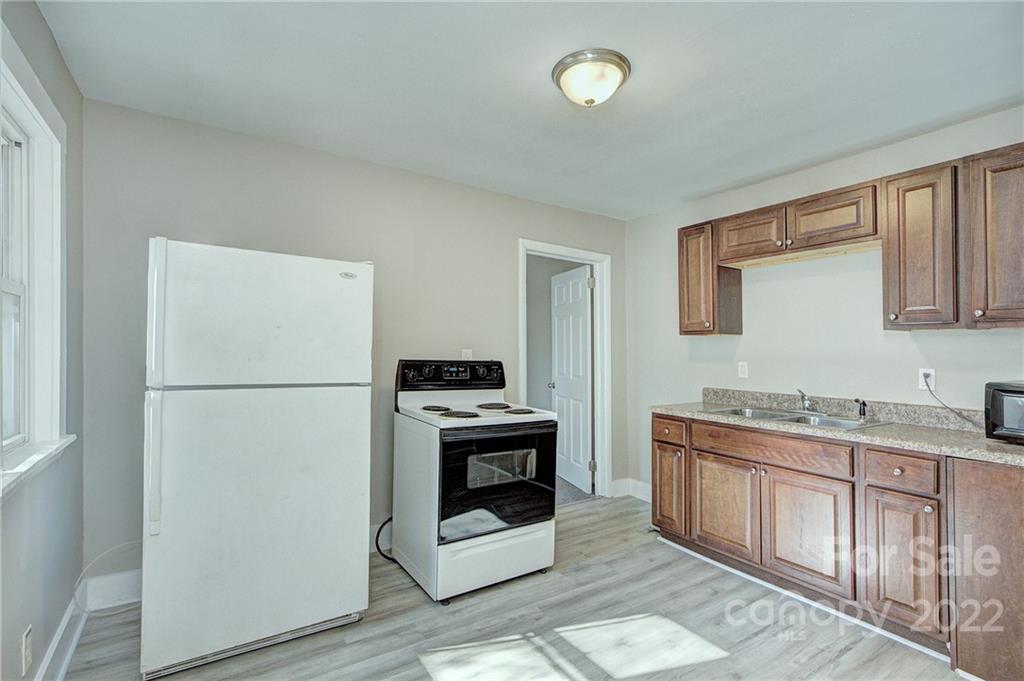3128-3130 Ridge Avenue Charlotte, NC 28208 - Photo 7 of 22 a kitchen with stainless steel appliances a refrigerator sink and stove