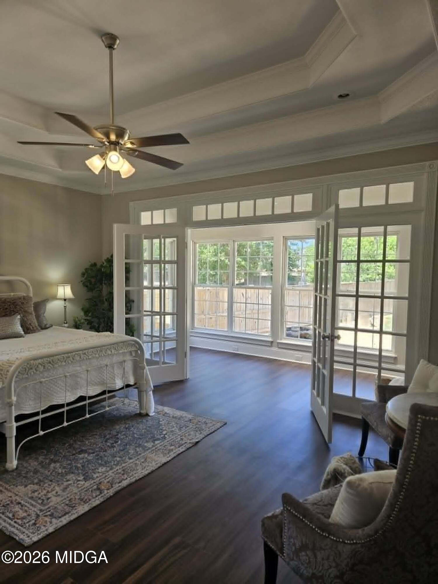 214 Tivoli Park Road Centerville, GA 31028 - Photo 11 of 26 a spacious bedroom with a bed a couch and a chandelier
