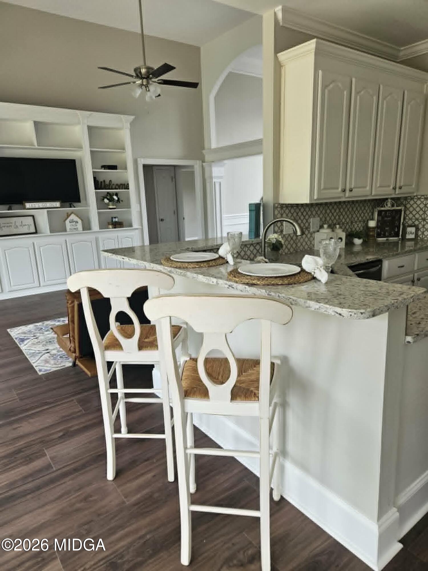 214 Tivoli Park Road Centerville, GA 31028 - Photo 3 of 26 a kitchen with stainless steel appliances granite countertop a dining table chairs and granite counter tops