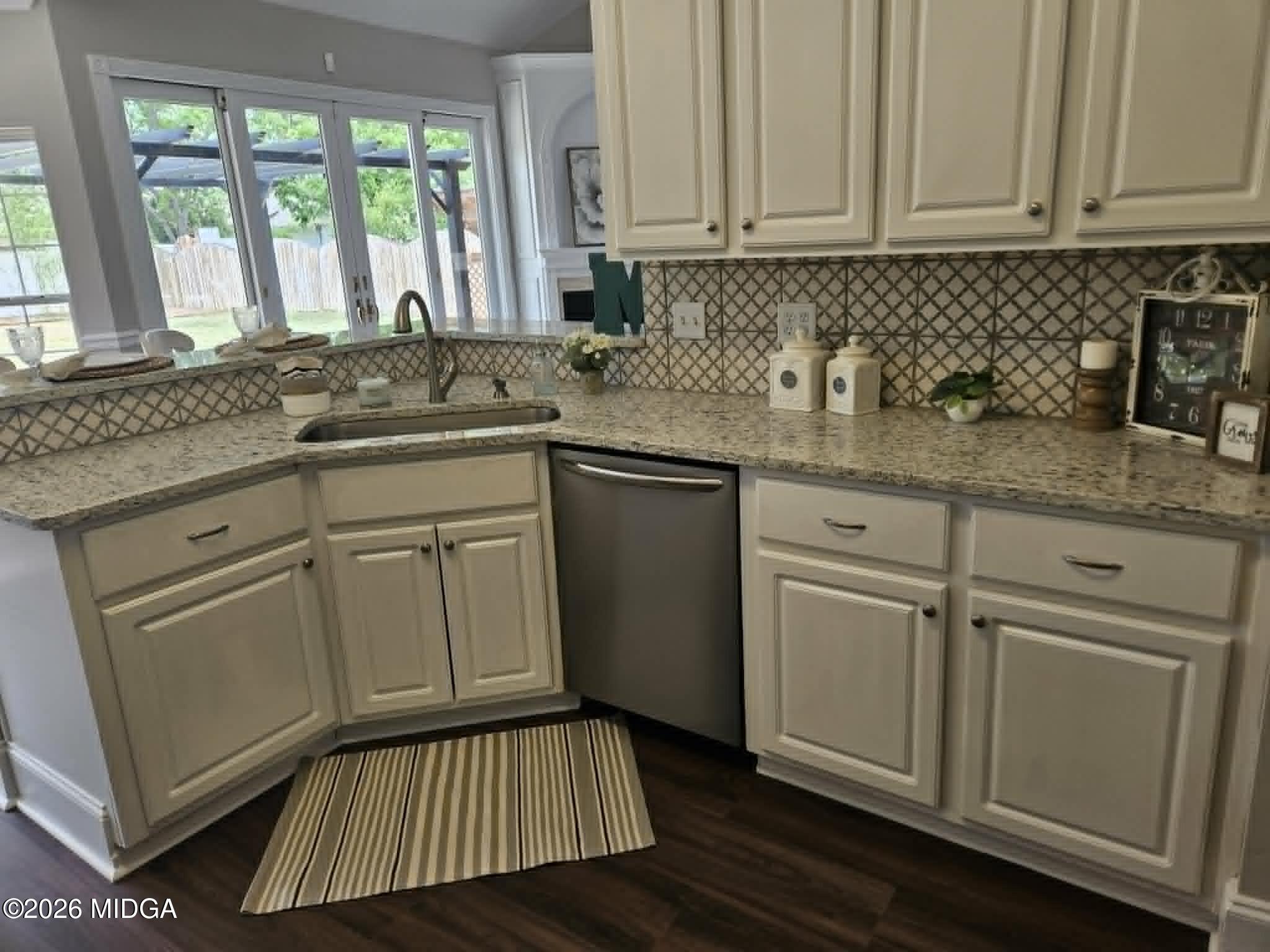 214 Tivoli Park Road Centerville, GA 31028 - Photo 6 of 26 a kitchen with white cabinets and sink