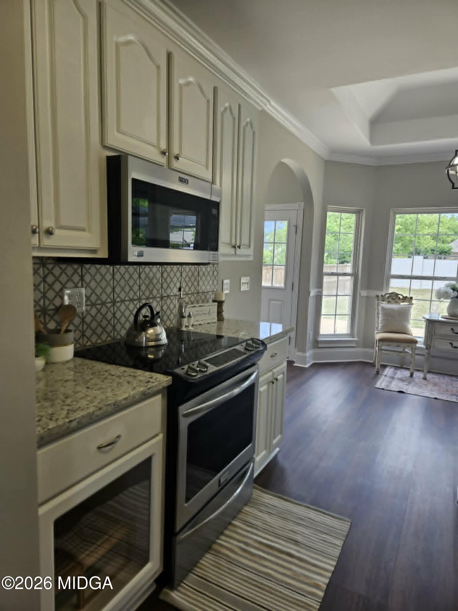 214 Tivoli Park Road Centerville, GA 31028 - Photo 7 of 26 a kitchen with stainless steel appliances granite countertop a stove a sink and a microwave