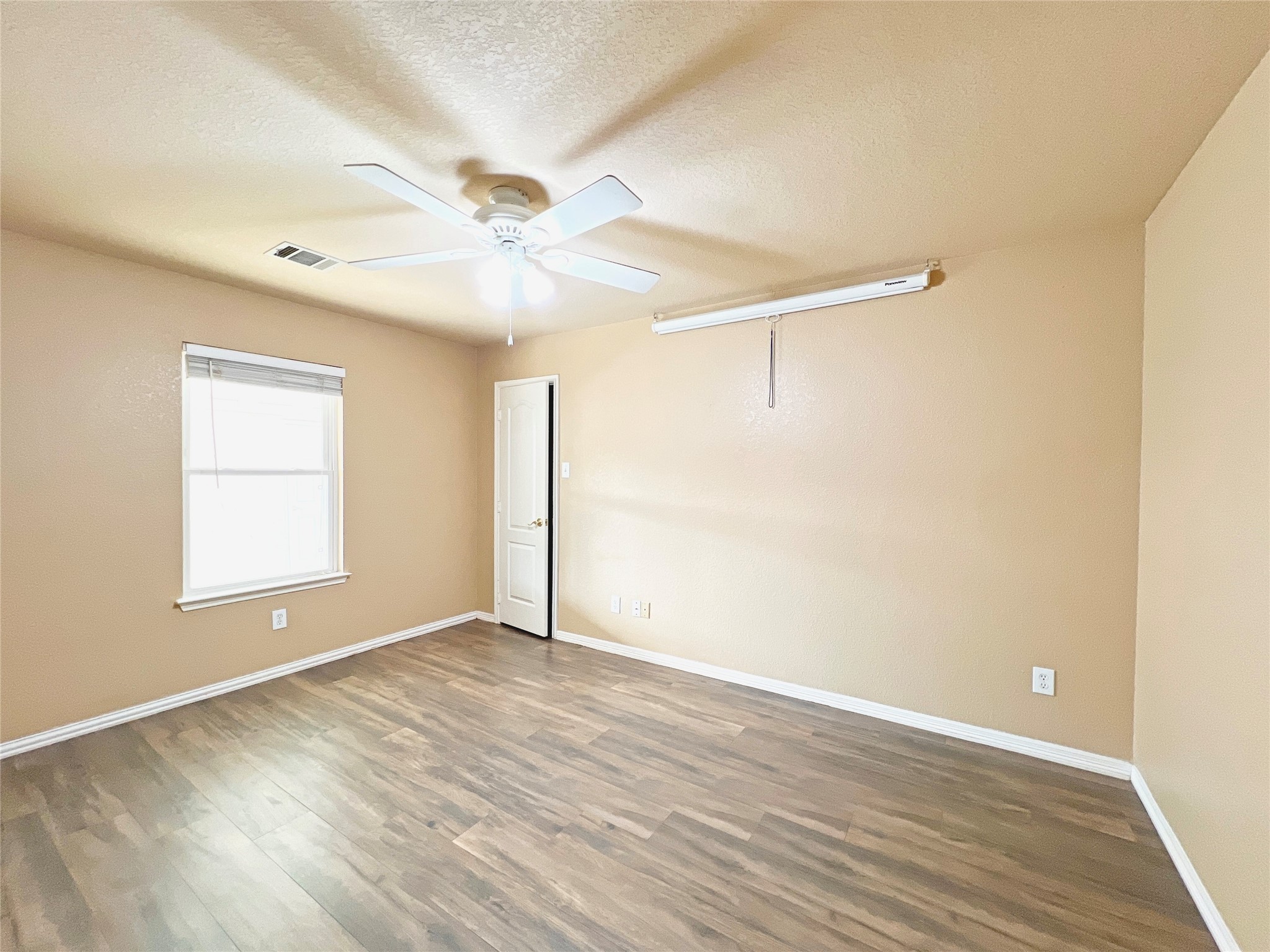 10018 San Ignacio Houston, TX 77075 - Photo 11 of 14 a view of an empty room with wooden floor and a window