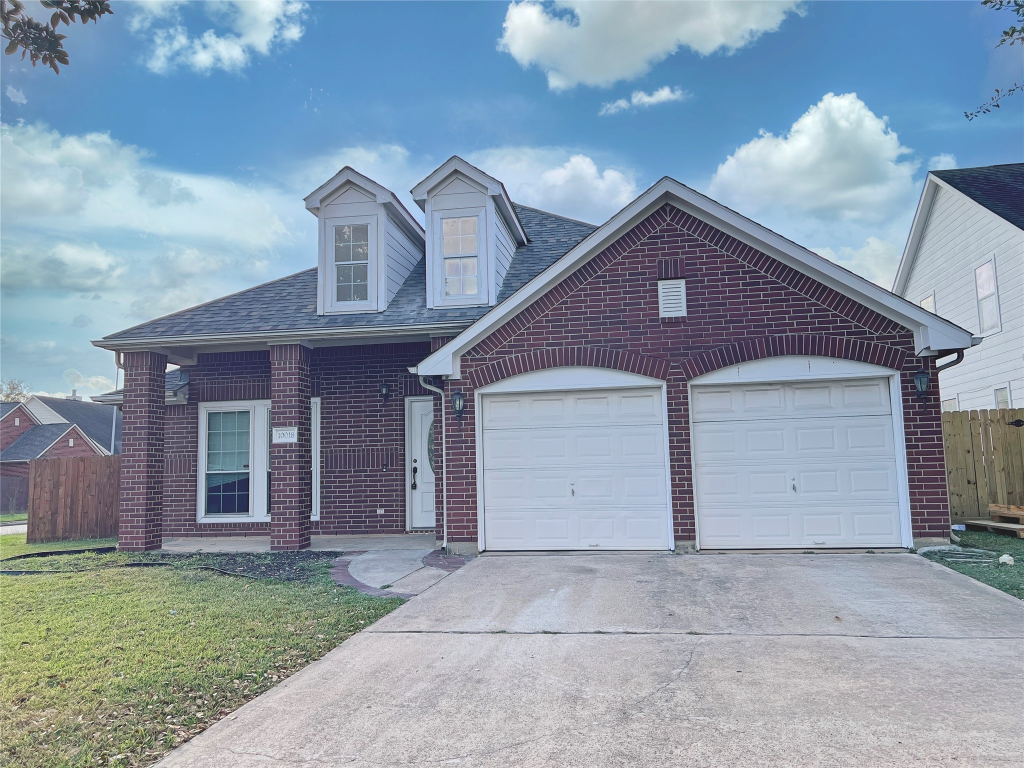 10018 San Ignacio Houston, TX 77075 - Photo 2 of 14 a front view of a house with a yard and garage