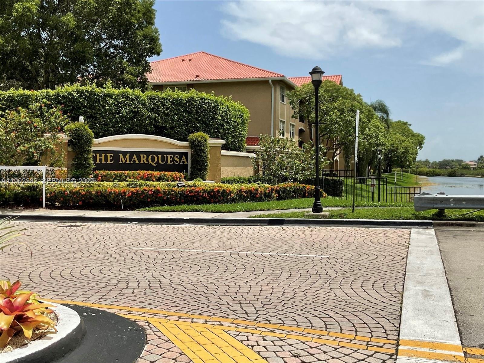 11730 Southwest 2nd Street, Unit 12202 Pembroke Pines, FL 33025 - Photo 1 of 18 a sign that is sitting on the side of a road