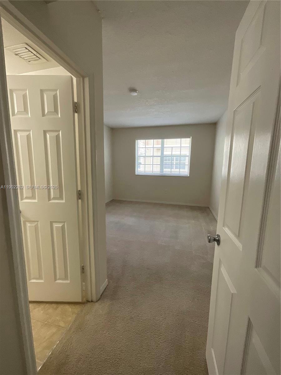 11730 Southwest 2nd Street, Unit 12202 Pembroke Pines, FL 33025 - Photo 13 of 18 an empty room with windows